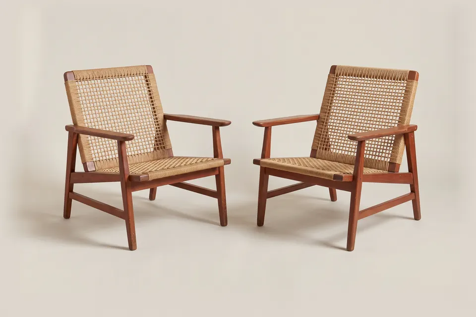 Pair of armchairs, c. 1962. Mahogany with woven sisal seats.